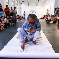 Front: Lee Kun-Yong performing Snail’s Gallop, first performed in 1979, (re-performed in 2018) paper, charcoal, dimensions variable. Pre-performance view, 4A Centre for Contemporary Asian Art as part of Lee Kun-Yong: Equal Area;commissioned by 4A Centre for Contemporary Art, Sydney; Image: Document Photography