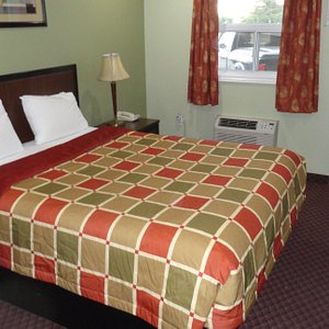Budget Inn in Port Hope, image may contain: Lamp, Bed, Furniture, Painting
