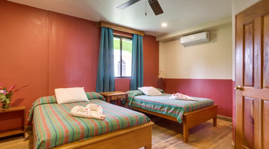 Deluxe room with two double beds and private bathroom.