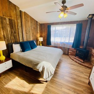 Master bedroom with fire place in the Adventure King Suite