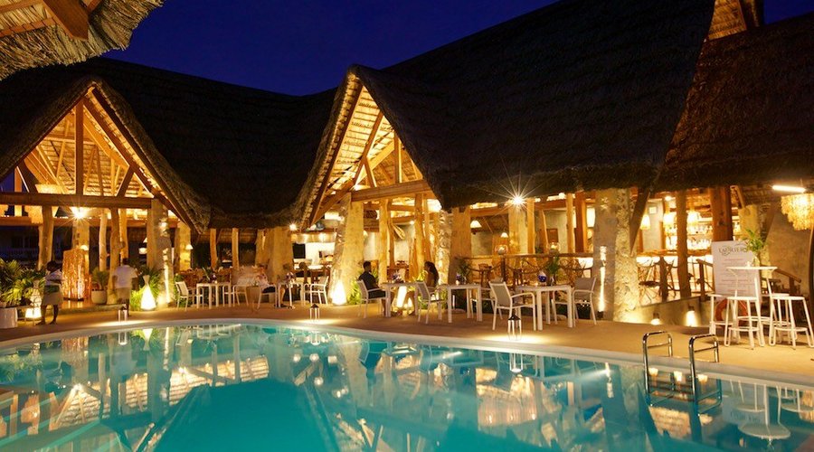 Dine in our beautiful thatched restaurant, or poolside under the stars.