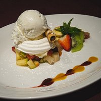 Meringue Delight with ice-cream, fruit cocktail and whipped cream.