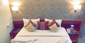 Hotel Gaurav in Jaipur, image may contain: Cushion, Home Decor, Pillow, Bed