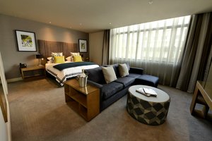 Distinction Dunedin Hotel in Dunedin, image may contain: Couch, Furniture, Bedroom, Indoors