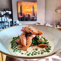 Pan Seared Salmon with Fried New Potatoes, Peas, and Chive Cream.