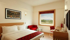 Red Fox Hotel, Delhi Airport in New Delhi, image may contain: Corner, Bed, Furniture, Monitor