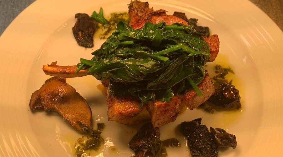 Pan fried local pork chop, crispy polenta, spinach, wild mushrooms, garlic persillade 