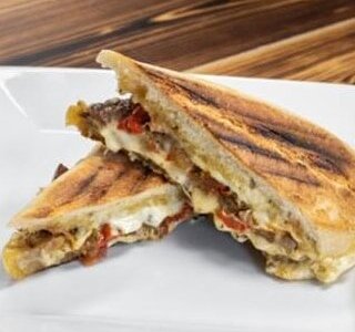 El Gaucho. Grass-Fed Steak, Chimichurri Mayo, Gouda, Caramelized Onions and Peppers and more Chimichurri for good measure!