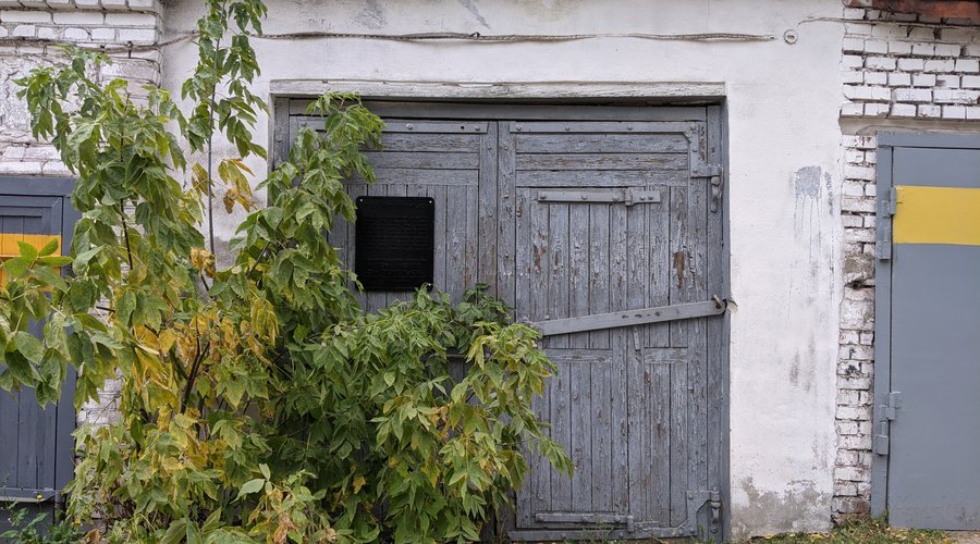 Garage doors with the memorial plate. It's said to be the place where one of the first IT businesses in Belarus started.