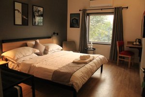 Loft 24 in Jaipur, image may contain: Chair, Furniture, Bed, Dorm Room