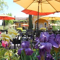 Tuscan-style gardens provide the ideal setting to savor a glass of wine & share a meal.