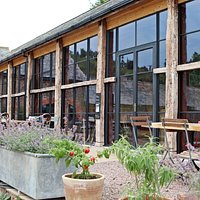 The Lost Kitchen restaurant in Devon is situated inside a sympathetically restored former Linhay Barn. You may eat inside or dine on the garden terrace.