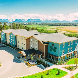 Aspen Suites Hotel in Homer with Kachemak Bay in the background.