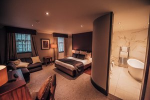 Busby Hotel in Clarkston, image may contain: Bedroom, Indoors, Furniture, Toilet