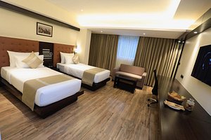 The Ocean Pearl Inn in Mangalore, image may contain: Wood, Interior Design, Bed, Floor