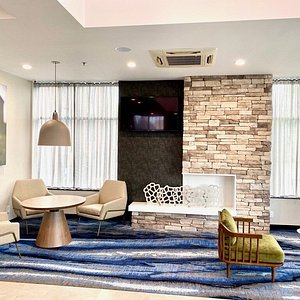 Fairfield Inn New York JFK Airport in Jamaica, image may contain: Home Decor, Living Room, Rug, Table