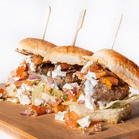 Our Lamb Slider Appetizers! 3 Mouth watering in-houses seasoned patties, char-grilled, and topped with feta cheese and pico de gallo.