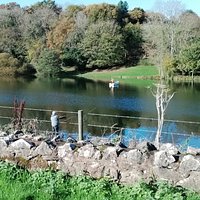 Reservoir with fisherman and boat