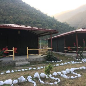 Tent cottages set amongst a hilly backdrop