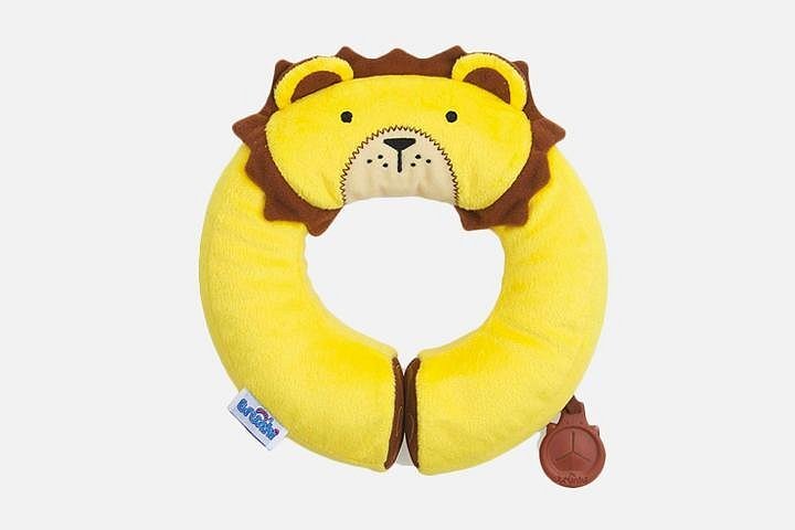 A yellow plush neck pillow for toddlers. The top of the pillow has has a playful design of a lions head. It includes brown frills for the the mane.