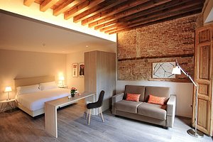 San Lorenzo Suites Hotel in San Lorenzo de El Escorial, image may contain: Interior Design, Couch, Bed, Chair
