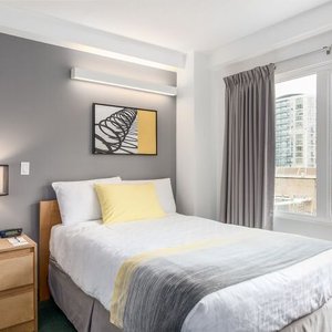 YWCA Hotel Vancouver in Vancouver, image may contain: Bed, Furniture, Home Decor, Lamp