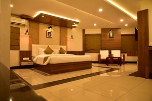 White Suite Hotel in Kozhikode, image may contain: Lighting, Interior Design, Resort, Hotel