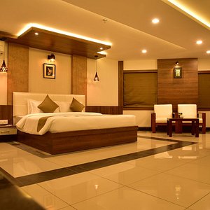 White Suite Hotel in Kozhikode, image may contain: Lighting, Interior Design, Resort, Hotel