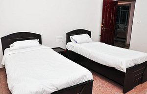 Hosamane Farm Inn in Sringeri, image may contain: Bed, Furniture, Hostel, Housing