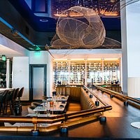 A look at some of our dining room booths as well as our raw bar and open kitchen.
