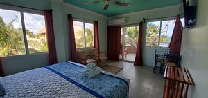 Island Magic Beach Resort in Caye Caulker, image may contain: Resort, Hotel, Bed, Chair