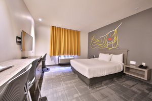 Hôtel Ô Laval in Laval, image may contain: Furniture, Bedroom, Dorm Room, Flooring