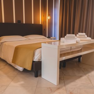 Hotel Continental in Reggio Calabria, image may contain: Flooring, Floor, Lighting, Bed