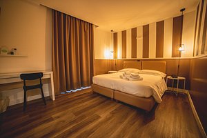 Hotel Continental in Reggio Calabria, image may contain: Flooring, Floor, Lighting, Bed