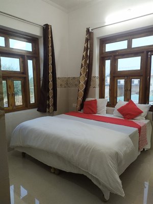 Surya Villa Resort in Mahwa, image may contain: Bed, Furniture, Interior Design, Bedroom