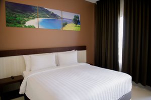 Simfony Hotel in Alor Island, image may contain: Furniture, Bed, Bedroom, Room