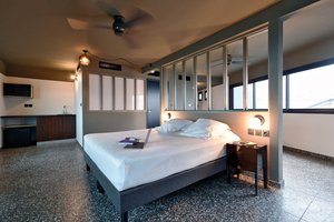 Dina Morgabine Saint Denis in Saint-Denis, image may contain: Ceiling Fan, Electrical Device, Bed, Monitor