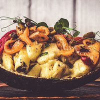 Roasted breadfruit topped with charred marinated peppers & olives, finished with cilantro chimichurri & fried capers (Vegan)