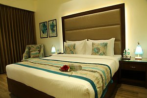 WJ Grand Hotel in Jalandhar, image may contain: Furniture, Bed, Bedroom, Indoors