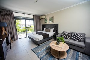 Sunshine Tower Hotel in Cairns, image may contain: Couch, Furniture, Home Decor, Bed