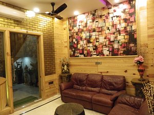 The Lodge B & B in Jaipur, image may contain: Interior Design, Couch, Living Room, Ceiling Fan