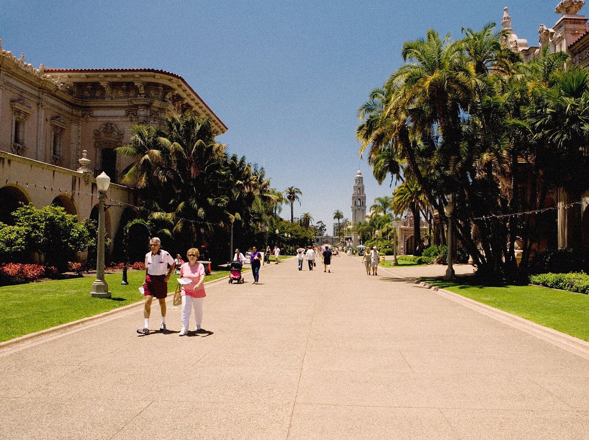 Tourists walking on a walkway in Balboa Park