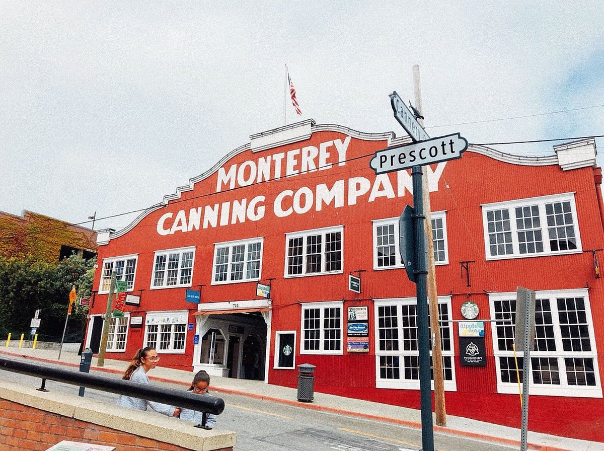 A photo of the Monterey Canning Company, two young girls are nearby.