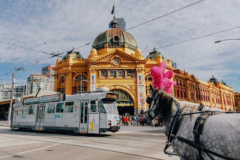 Tram passing Flinders Street Station in Melbourne where the Melbourne International Comedy Festival 2021 will be held.