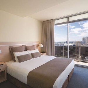 Interior view of bedroom in Two Bedroom Executive Suite with city view