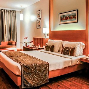 Comfort Inn Heritage in Mumbai, image may contain: Furniture, Home Decor, Bedroom, Bed