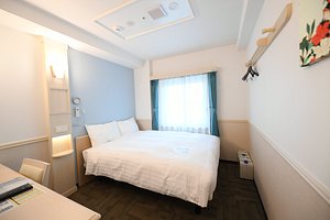 Toyoko Inn - Ulsan Samsandong in Ulsan, image may contain: Corner, Remote Control, Furniture, Bed