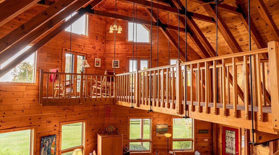 Catwalk off great room leading to a sitting area and an outside deck