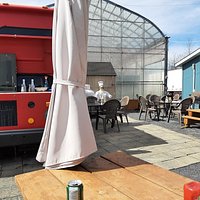 Cozy little space with a garden center backdrop in summer. The food will not disappoint.