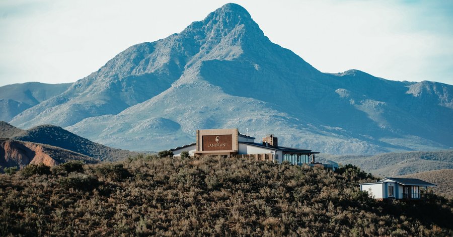 Main Lodge and one of the closer cabins with the Swartberg Mountain range in the background